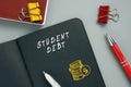 Business concept meaning STUDENT DEBT with phrase on the page. Student debtÃÂ refers to loans used to pay for college tuition that